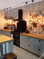 Rustic feeling kitchen with brickwork splashback